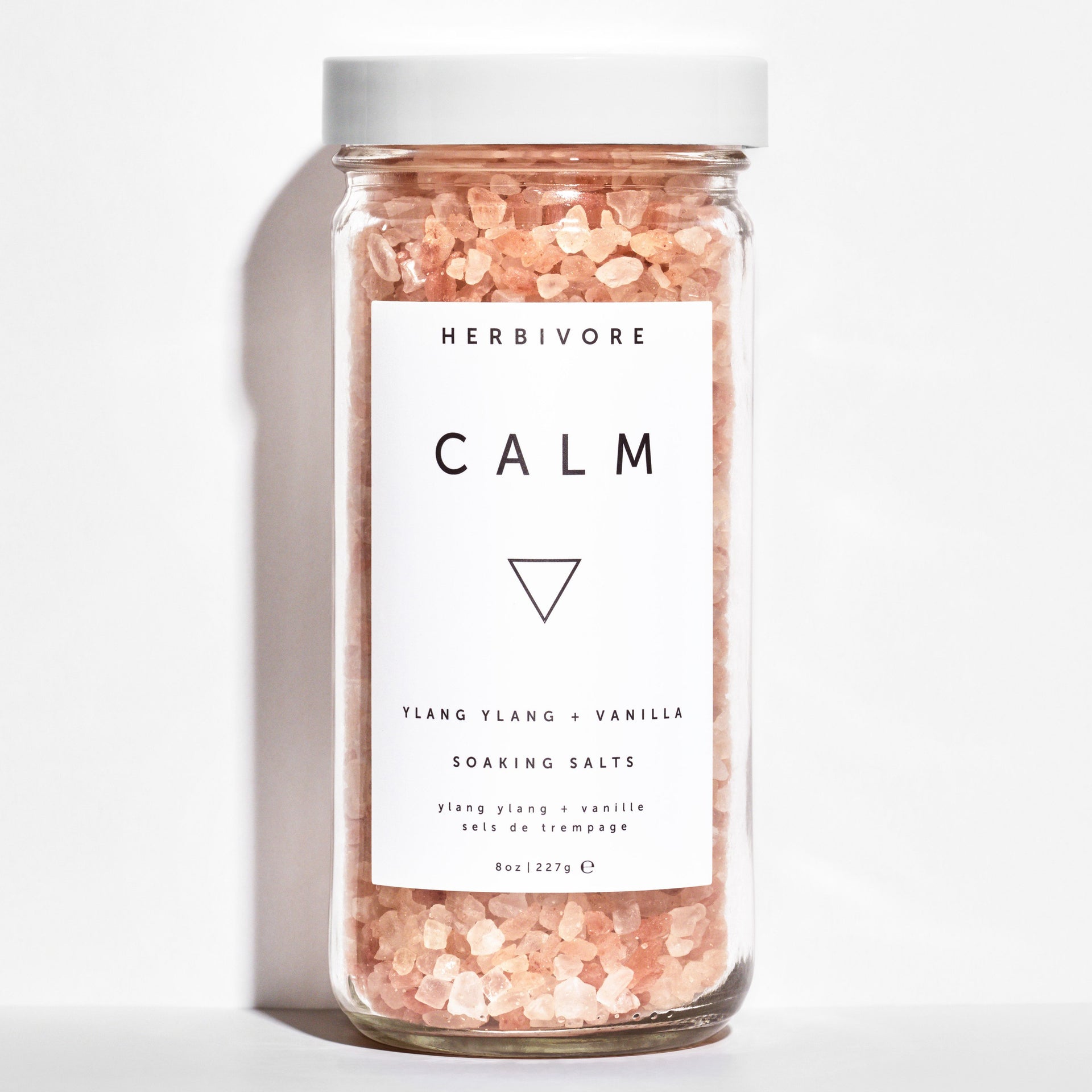 A glass jar filled with white salts and a minimalist label